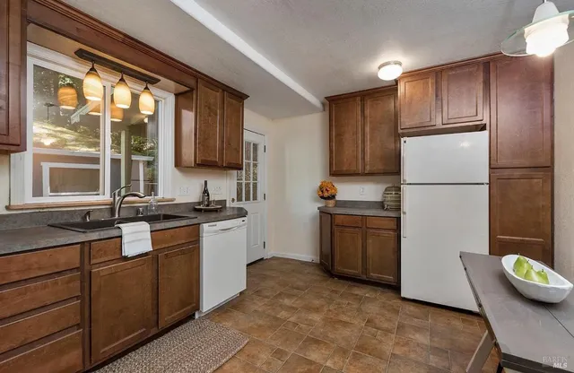 a kitchen with a refrigerator and a sink