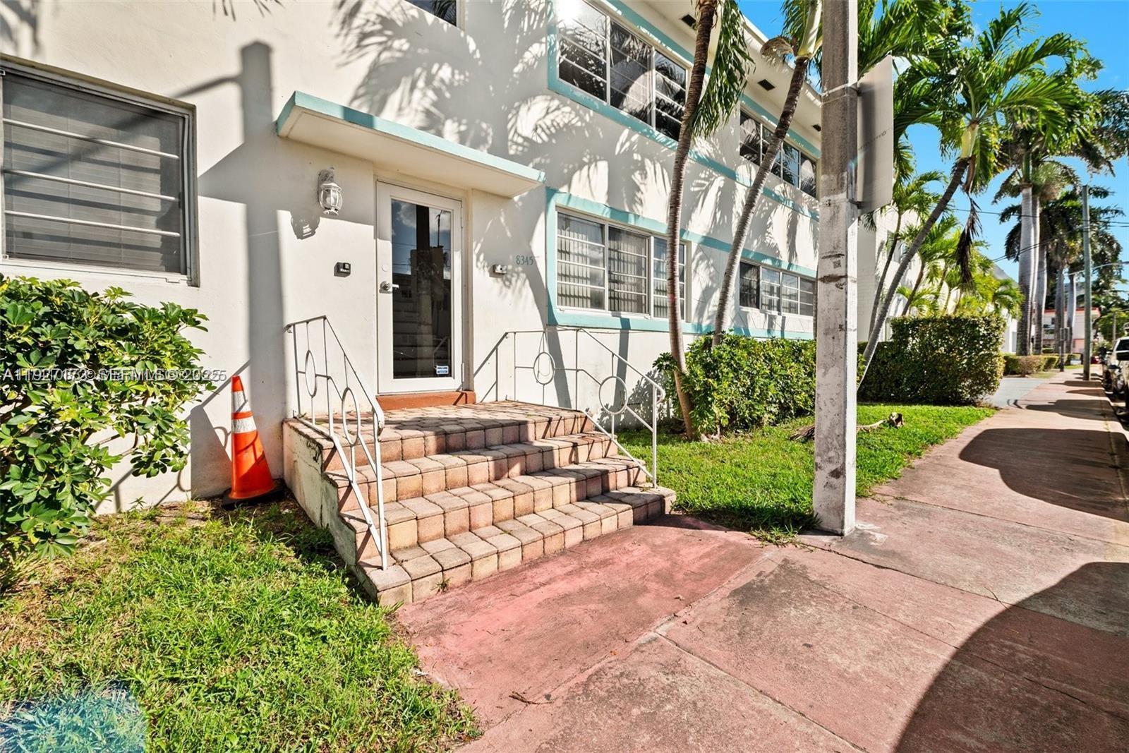 8345 Byron Avenue, Unit 6 Miami Beach, FL 33141 - Photo 1 of 23 a view of a house with backyard and a tree