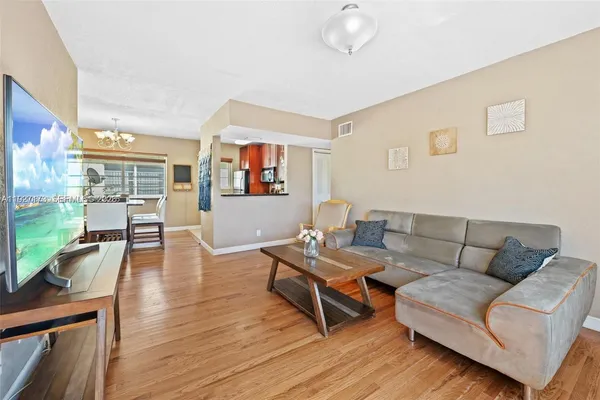 a living room with furniture and a wooden floor