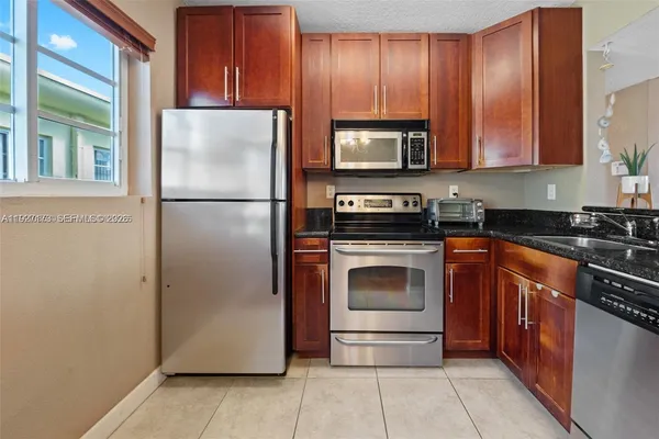 a kitchen with a refrigerator sink and microwave