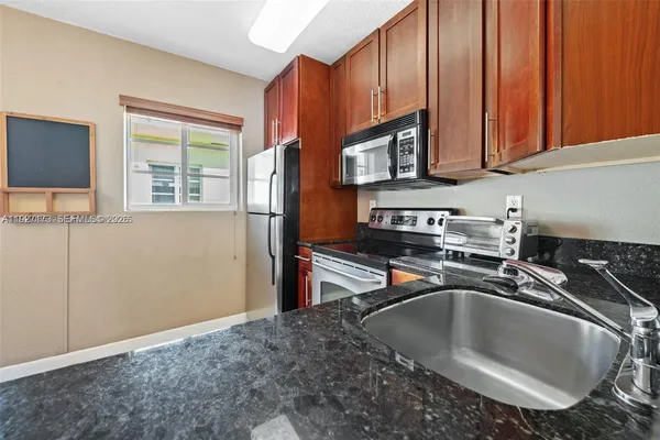 a kitchen with a sink stove and microwave