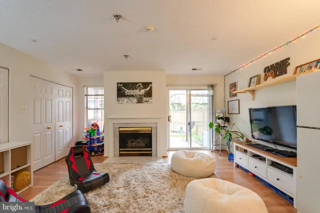 a living room with furniture flat screen tv and a fireplace