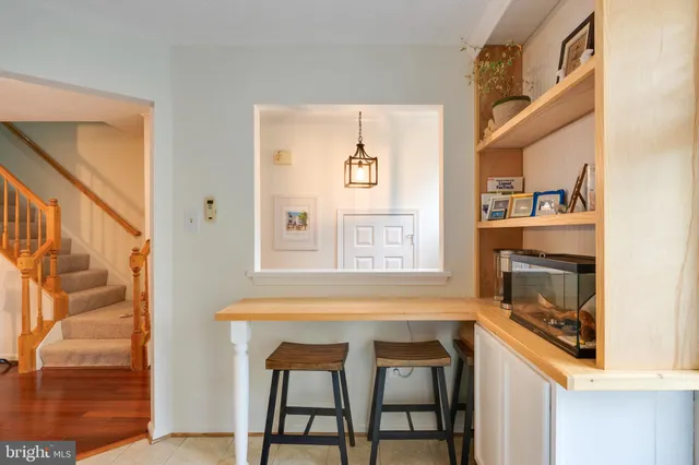 a living room with a table chairs and a window