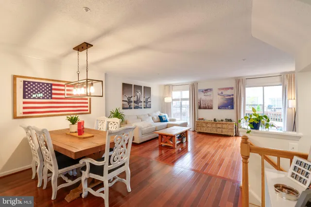 a dining room with furniture and wooden floor