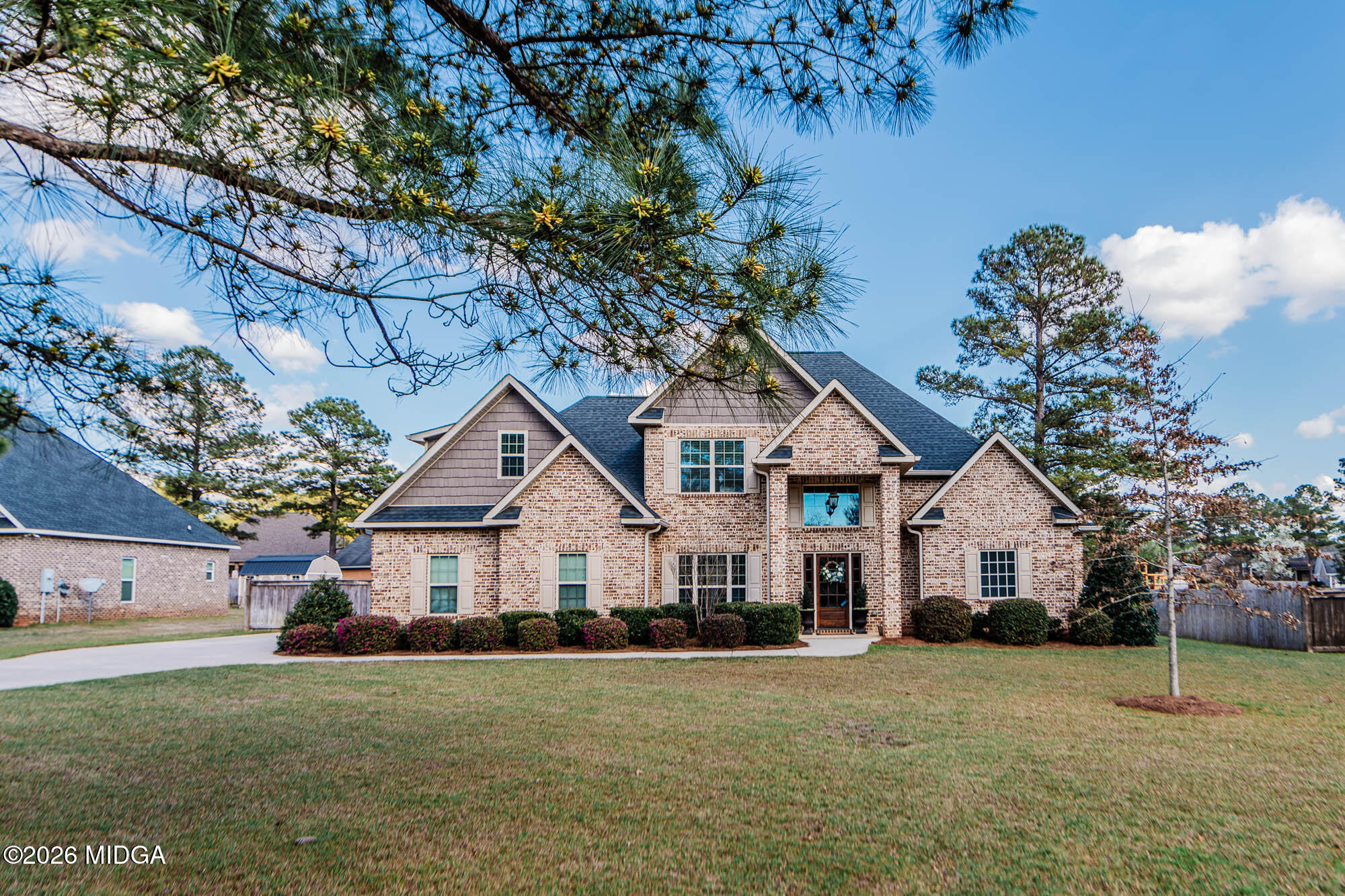 112 Bainbridge Lane Perry, GA 31069 - Photo 2 of 37 a front view of a house with a yard and garage
