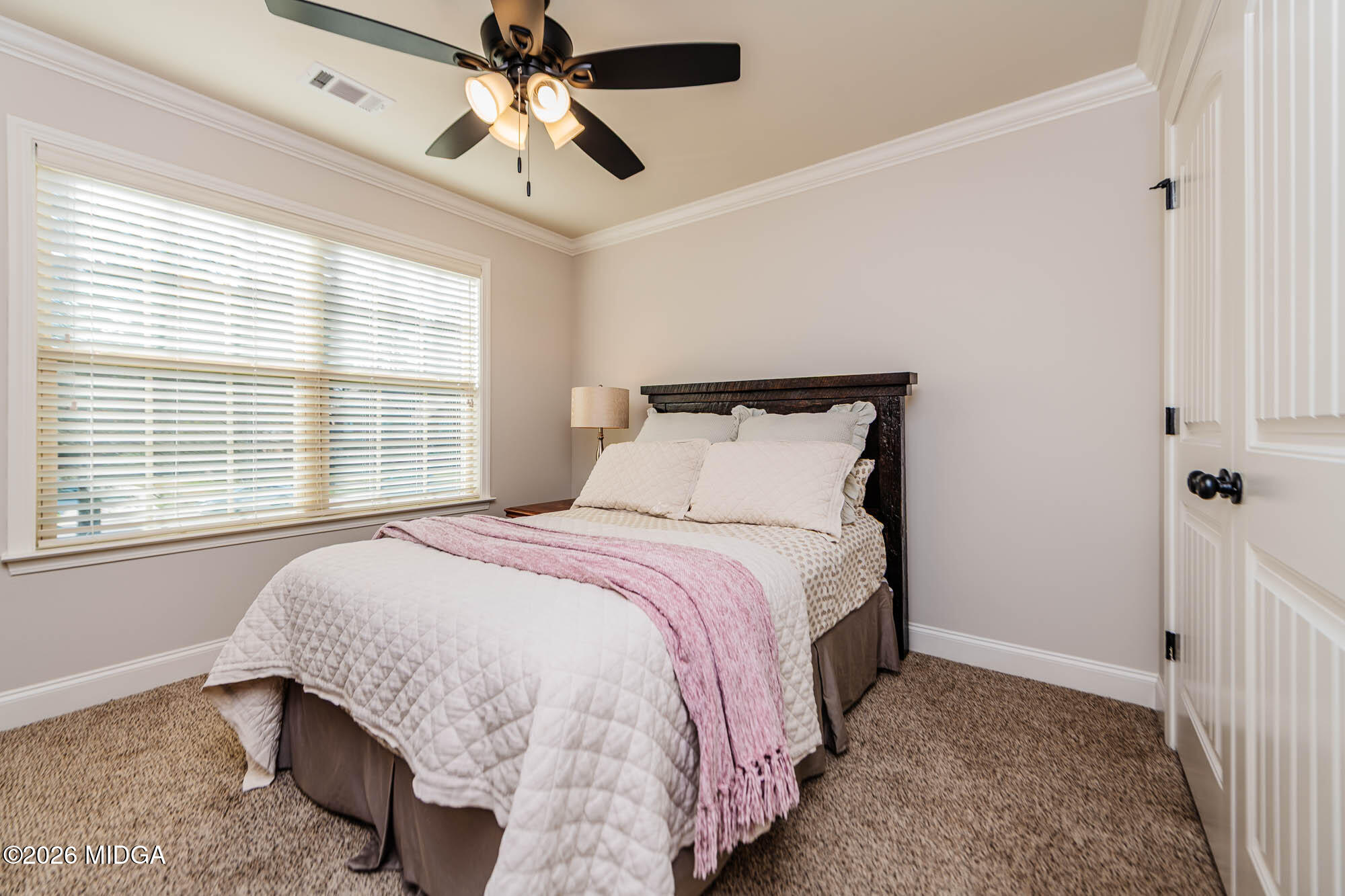 112 Bainbridge Lane Perry, GA 31069 - Photo 28 of 37 a bedroom with a bed and a chandelier