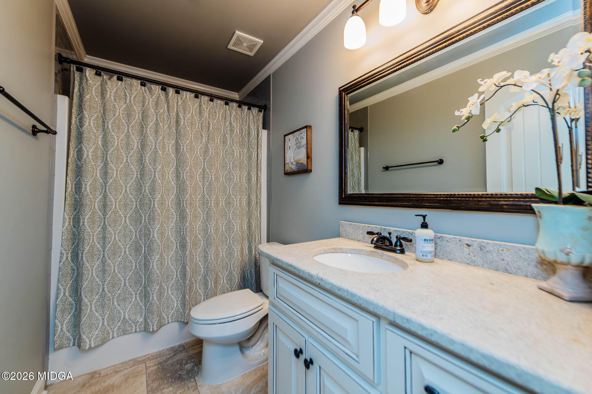 112 Bainbridge Lane Perry, GA 31069 - Photo 30 of 37 a bathroom with a toilet a sink and a mirror