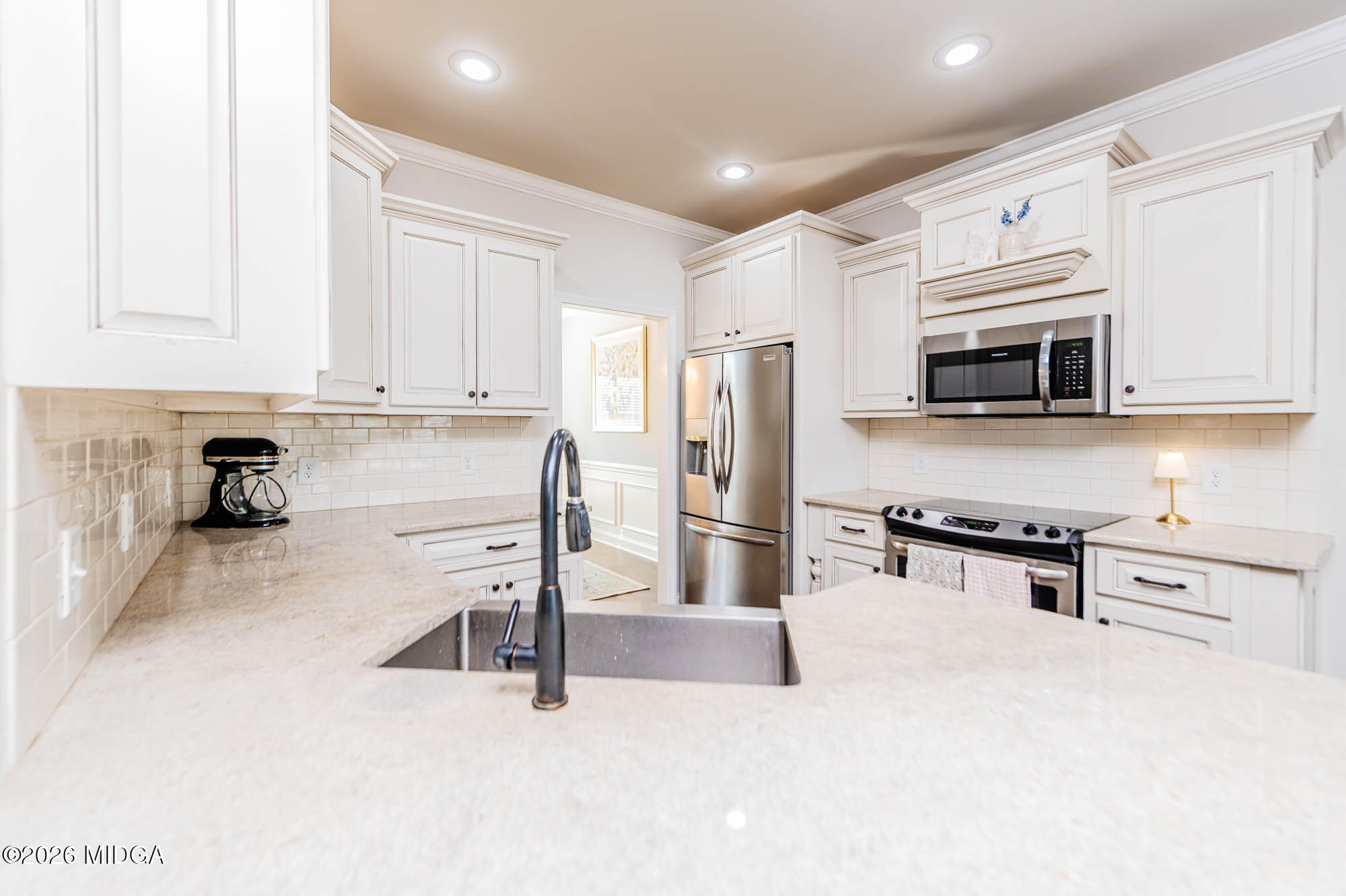 112 Bainbridge Lane Perry, GA 31069 - Photo 9 of 37 a kitchen with stainless steel appliances a stove a sink a refrigerator a window