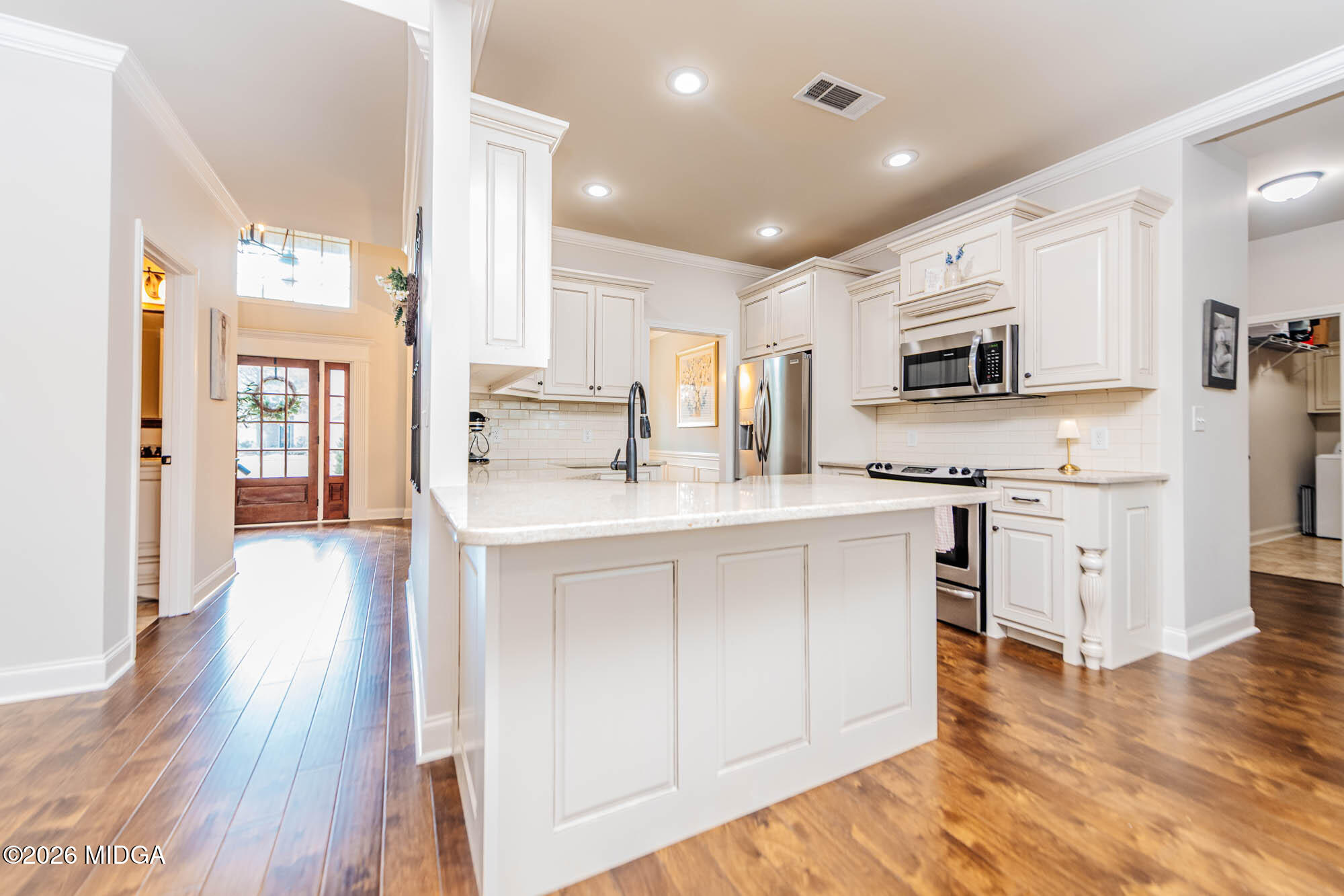 112 Bainbridge Lane Perry, GA 31069 - Photo 10 of 37 a kitchen with stainless steel appliances white cabinets a sink a stove a refrigerator and a microwave