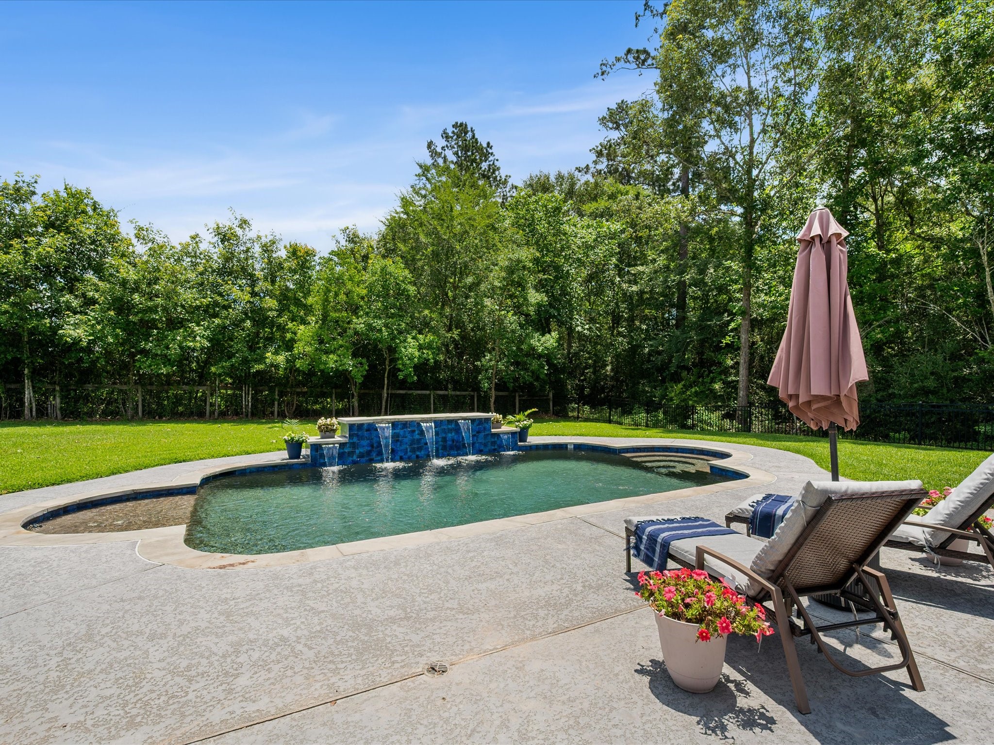 12618 Ranger Court Magnolia, TX 77354 - Photo 35 of 45 A shallow, extended pool patio area specifically designed to place lounge chairs directly in the water.