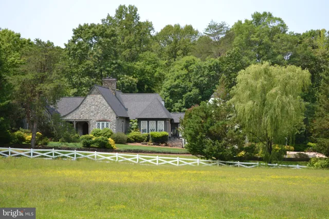 a living room with fireplace furniture and a large window