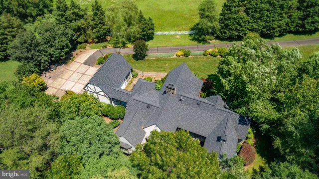 a view of a dining room with furniture and a chandelier