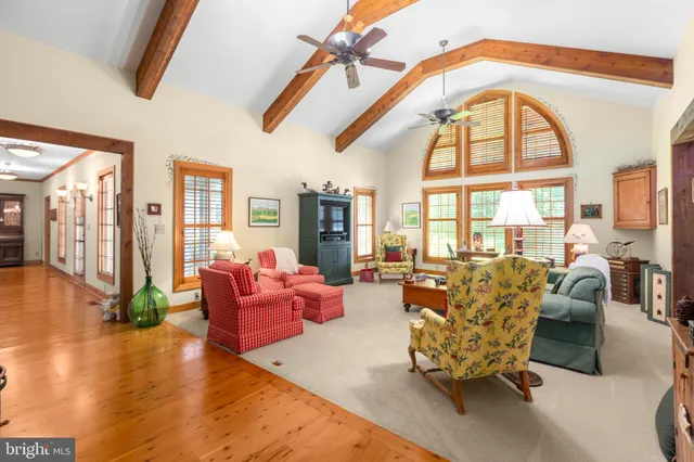 a bedroom with a bed furniture and a large window