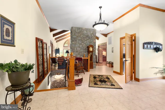 a bathroom with a sink toilet a mirror and next to a window