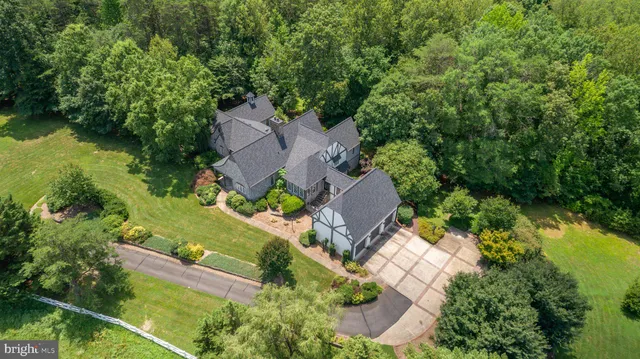 an aerial view of a residential houses with outdoor space and street view