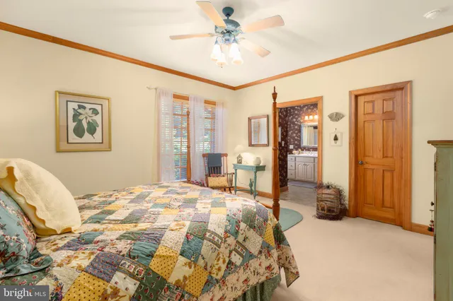 an aerial view of residential house with outdoor space and trees all around
