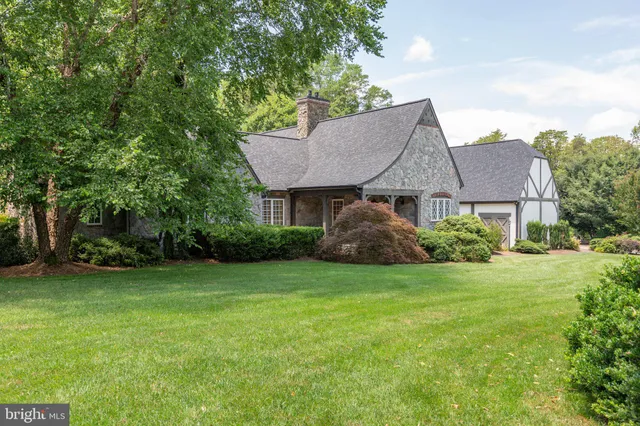 an aerial view of a house with a yard and garden