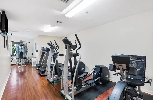 a view of a livingroom with hardwood floor and a gym equipment