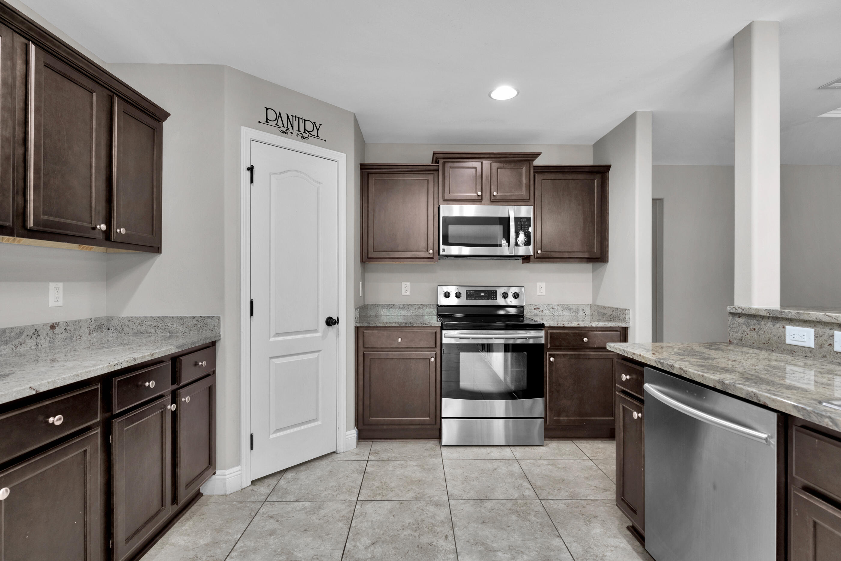 118 Trailwood Lane Crestview, FL 32539 - Photo 11 of 32 a kitchen with stainless steel appliances granite countertop a stove sink and cabinets