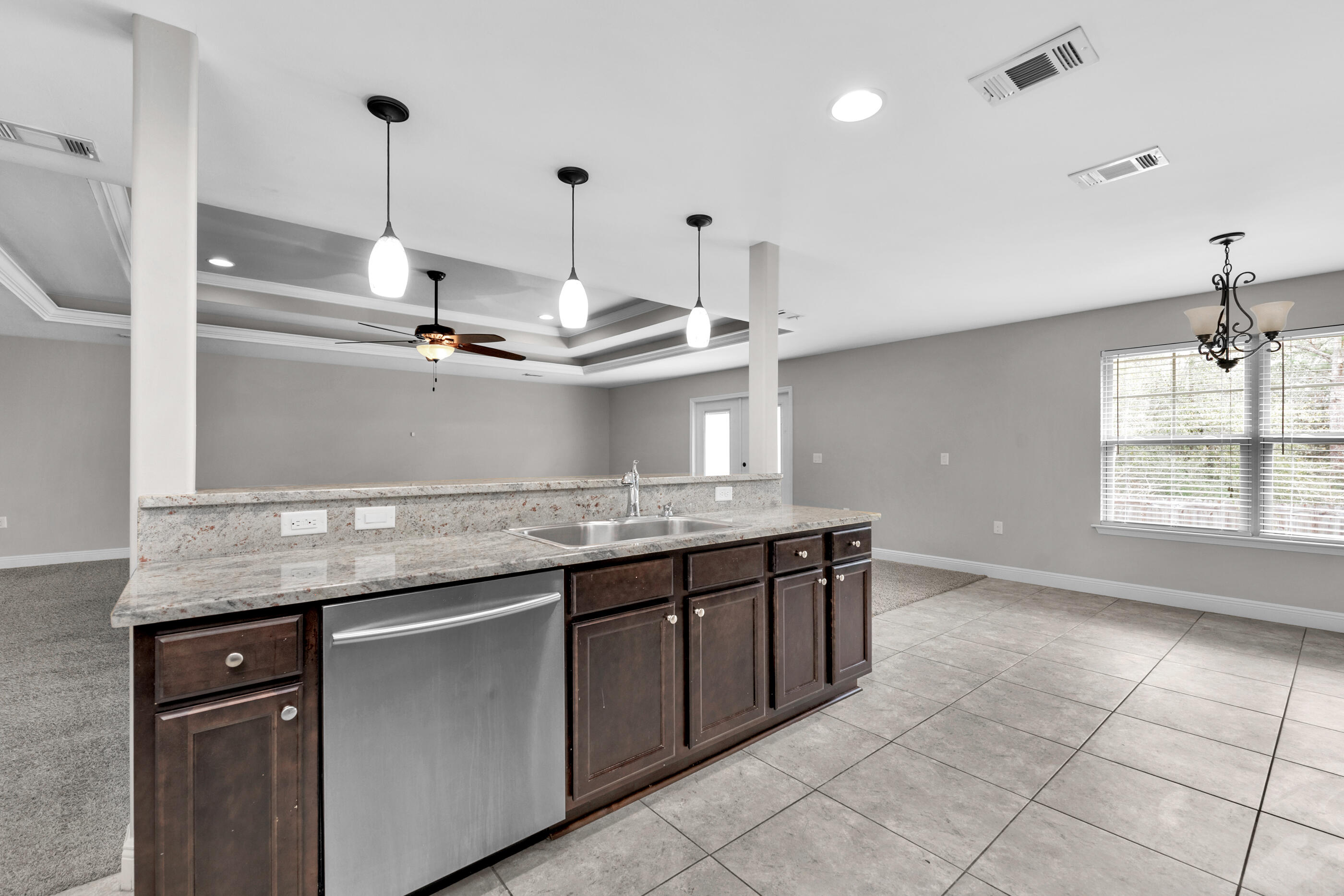 118 Trailwood Lane Crestview, FL 32539 - Photo 12 of 32 a kitchen with kitchen island granite countertop a sink a counter top space and cabinets
