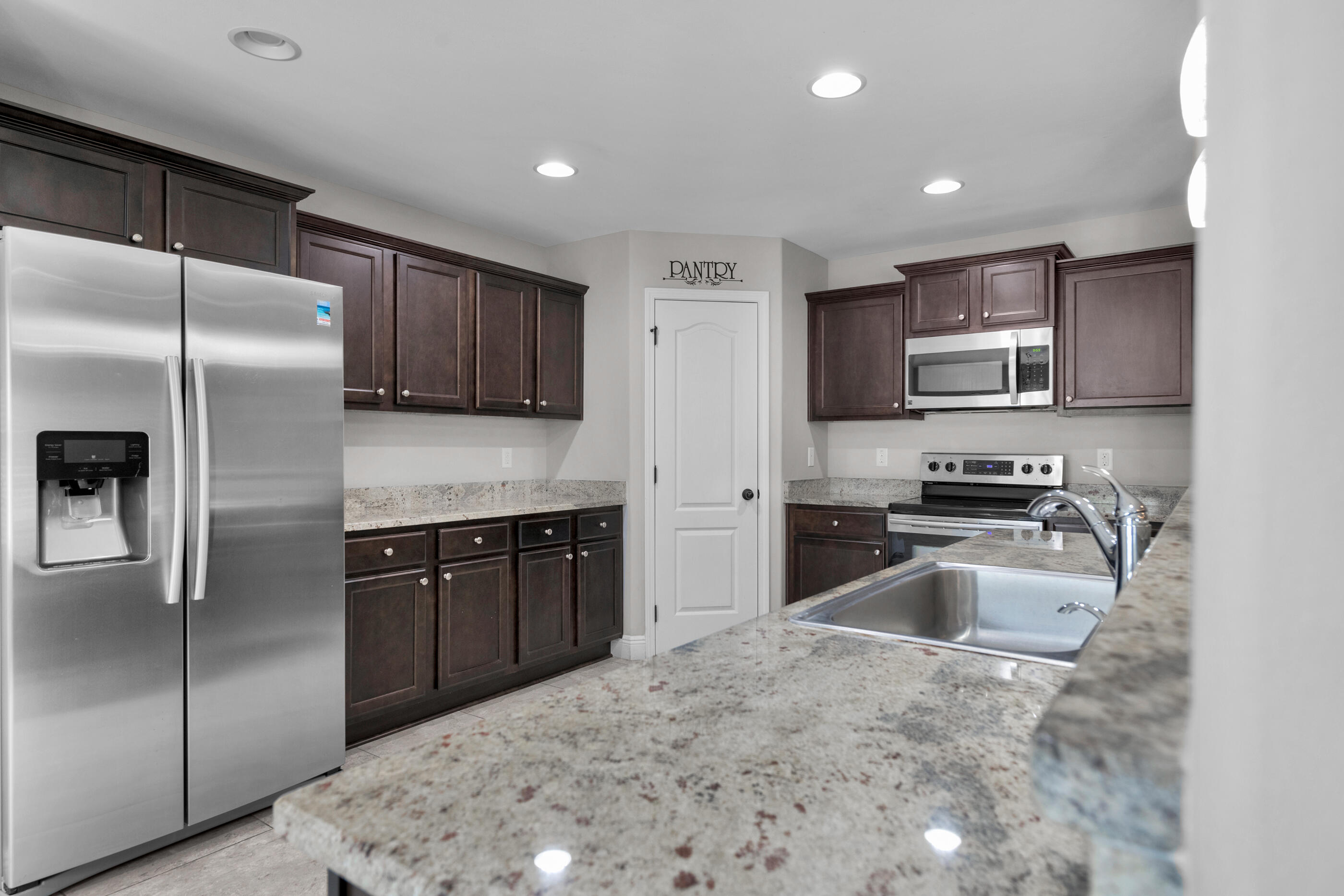 118 Trailwood Lane Crestview, FL 32539 - Photo 13 of 32 a kitchen with a refrigerator sink and microwave