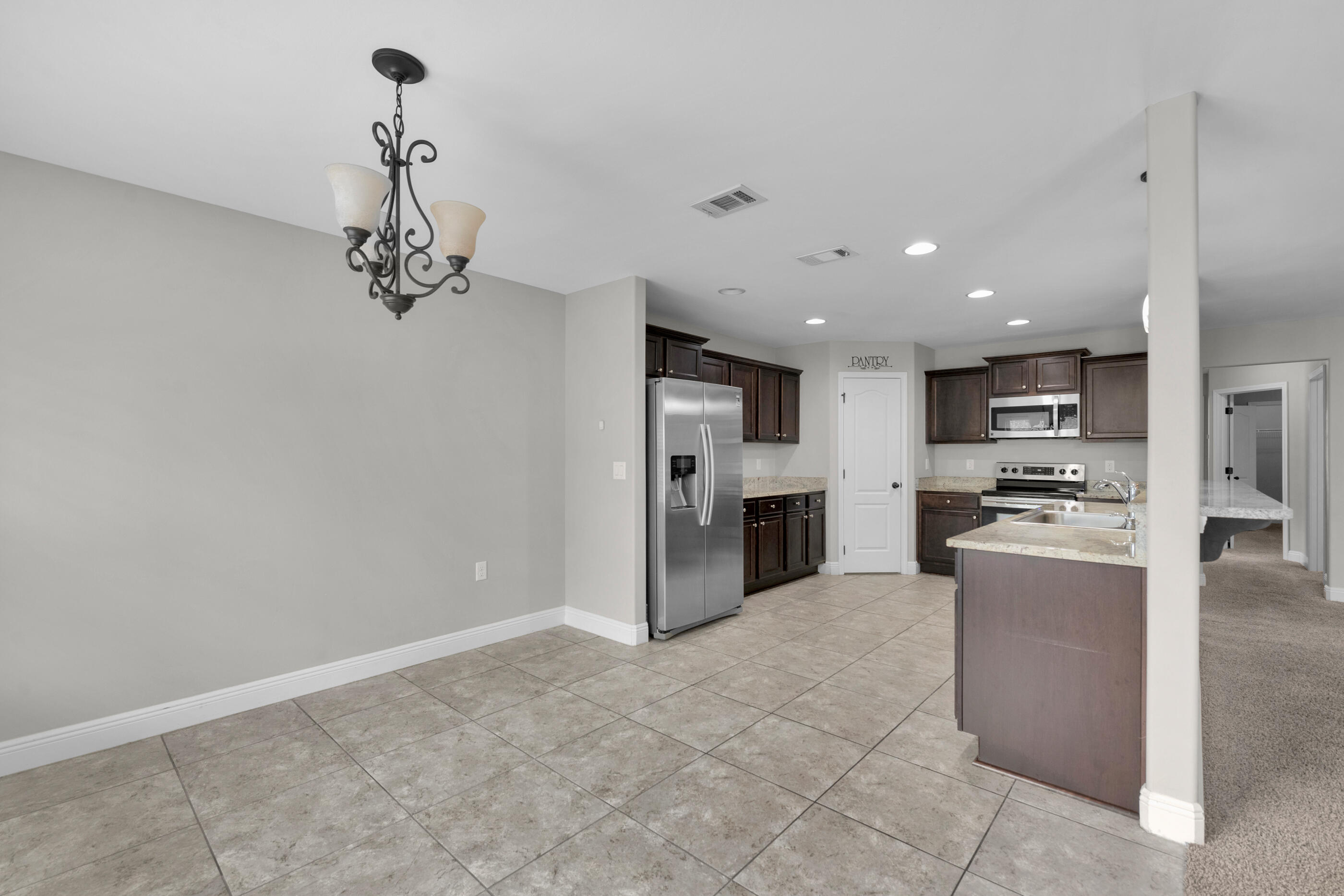 118 Trailwood Lane Crestview, FL 32539 - Photo 15 of 32 a open kitchen with stainless steel appliances granite countertop a refrigerator and a stove top oven