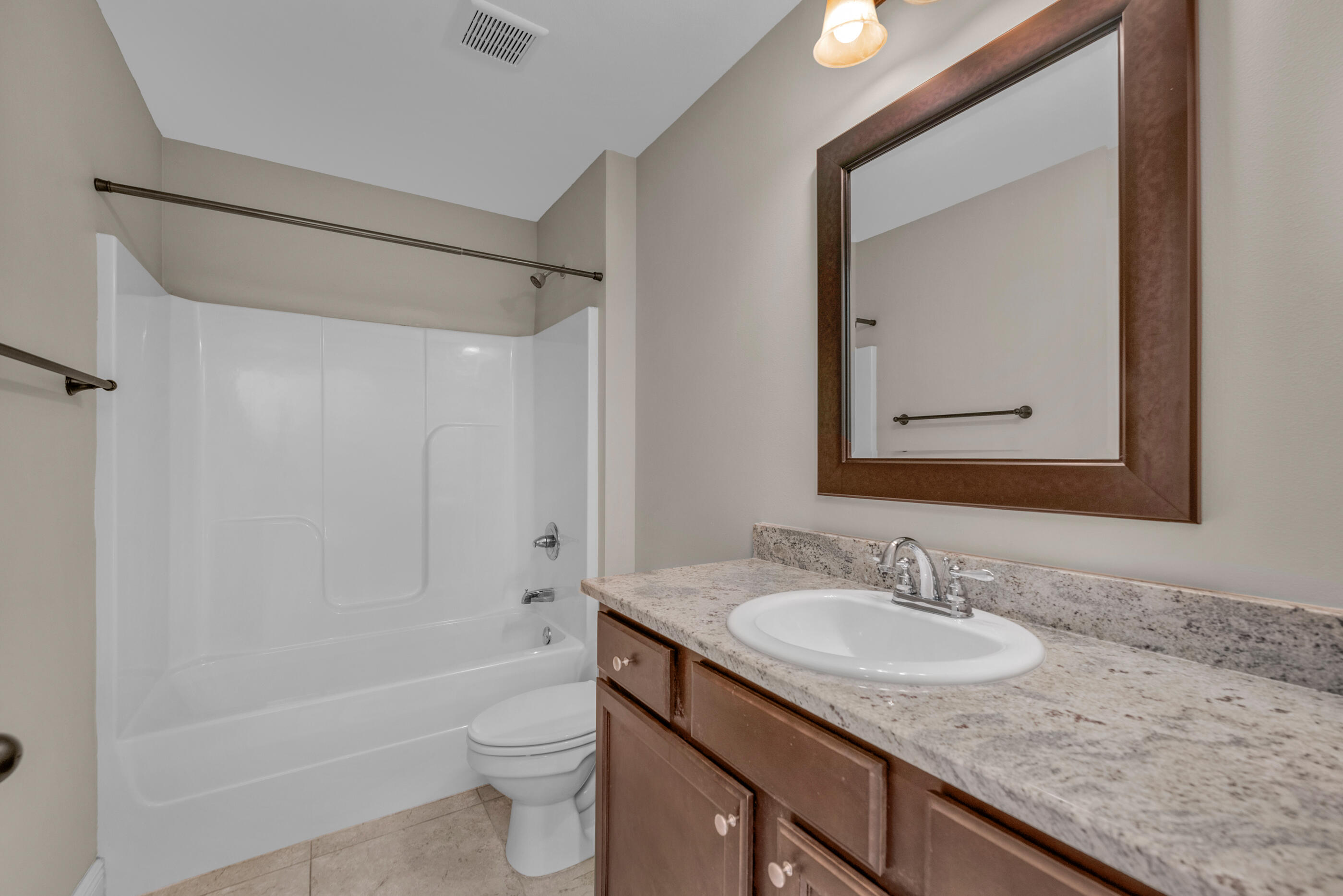 118 Trailwood Lane Crestview, FL 32539 - Photo 22 of 32 a bathroom with a granite countertop sink toilet and shower