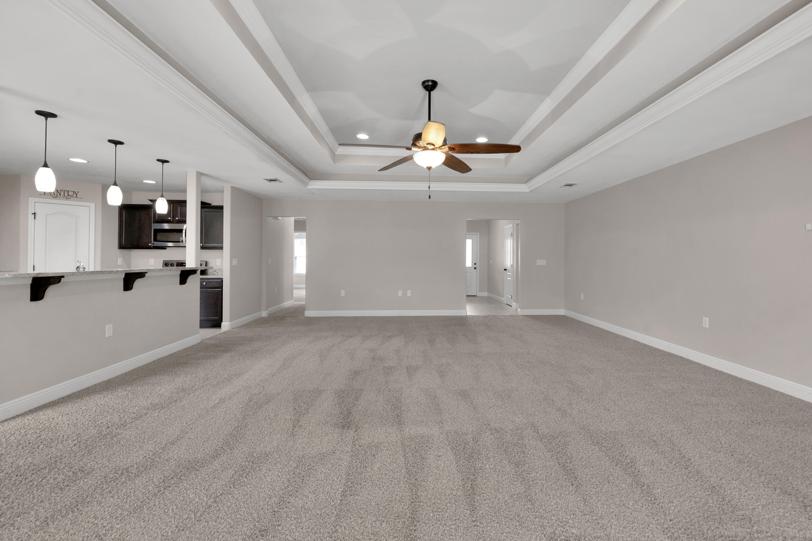 118 Trailwood Lane Crestview, FL 32539 - Photo 5 of 32 a view of a livingroom with a chandelier fan and kitchen view