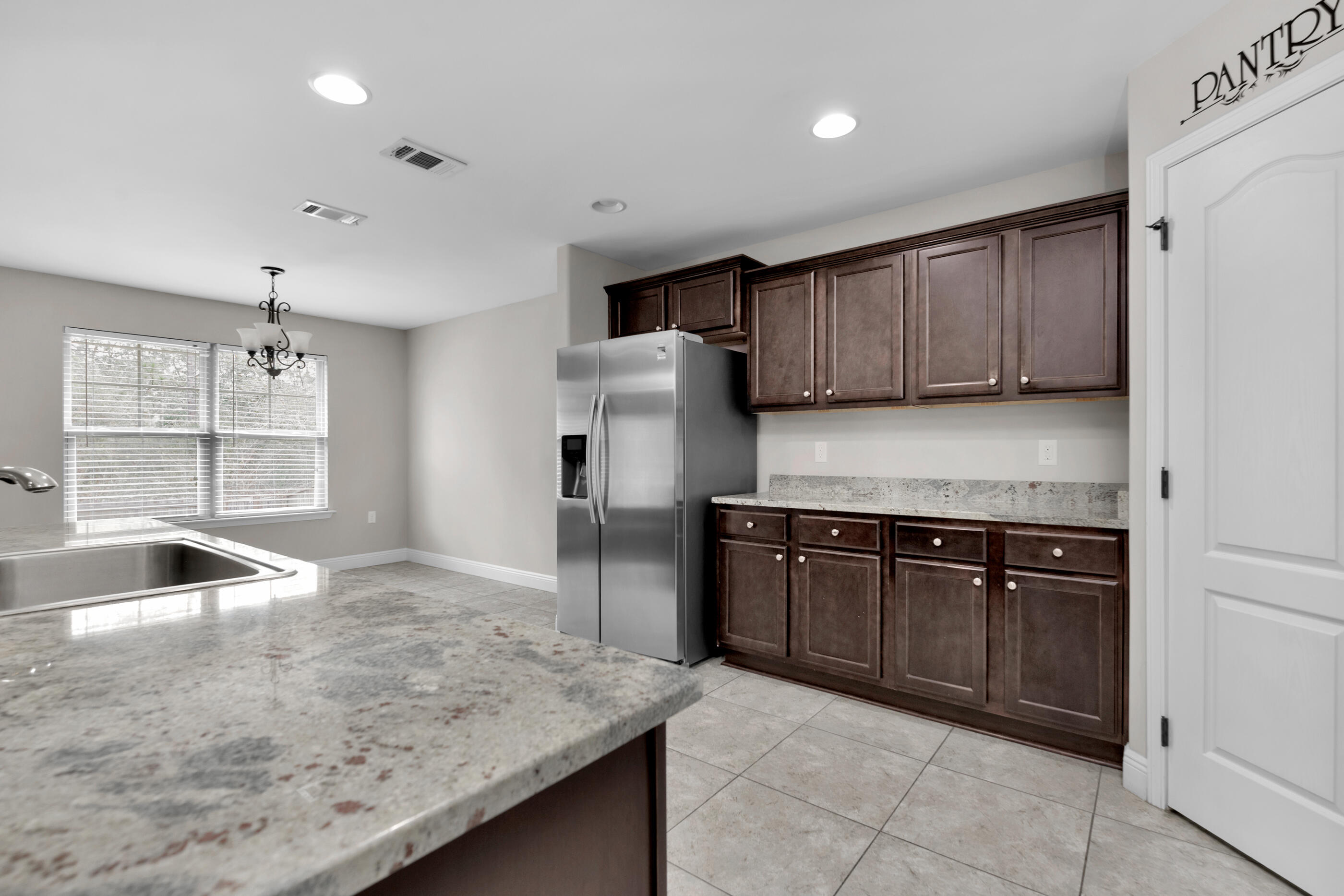 118 Trailwood Lane Crestview, FL 32539 - Photo 8 of 32 a kitchen with granite countertop a sink and a stove