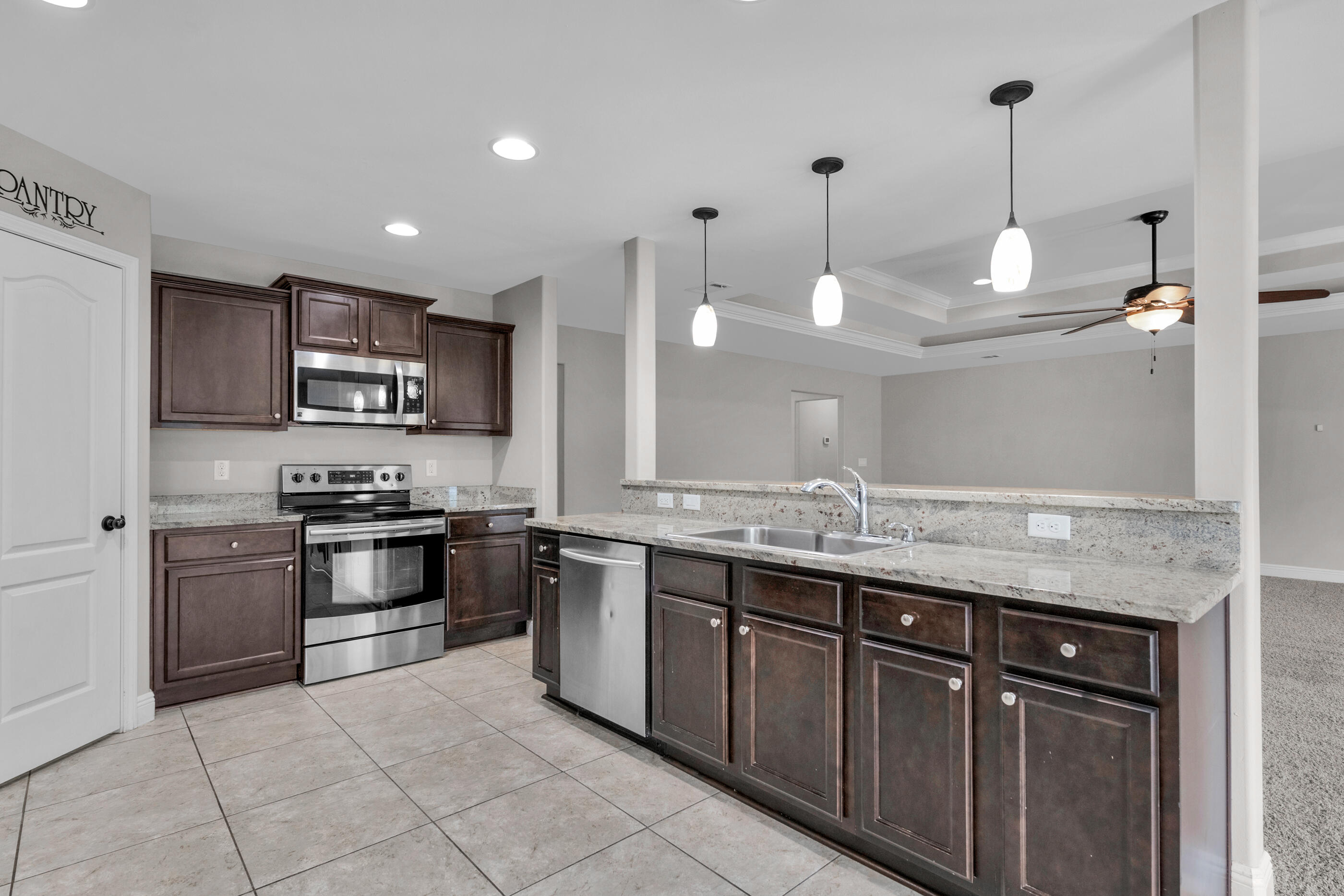 118 Trailwood Lane Crestview, FL 32539 - Photo 10 of 32 a kitchen with stainless steel appliances granite countertop a sink and stove top oven