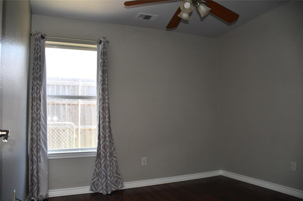 6241 Peach Tree Drive Midlothian, TX 76065 - Photo 13 of 19 Windowed room featuring wood-finish flooring, light gray walls, and a ceiling fan with integrated lighting