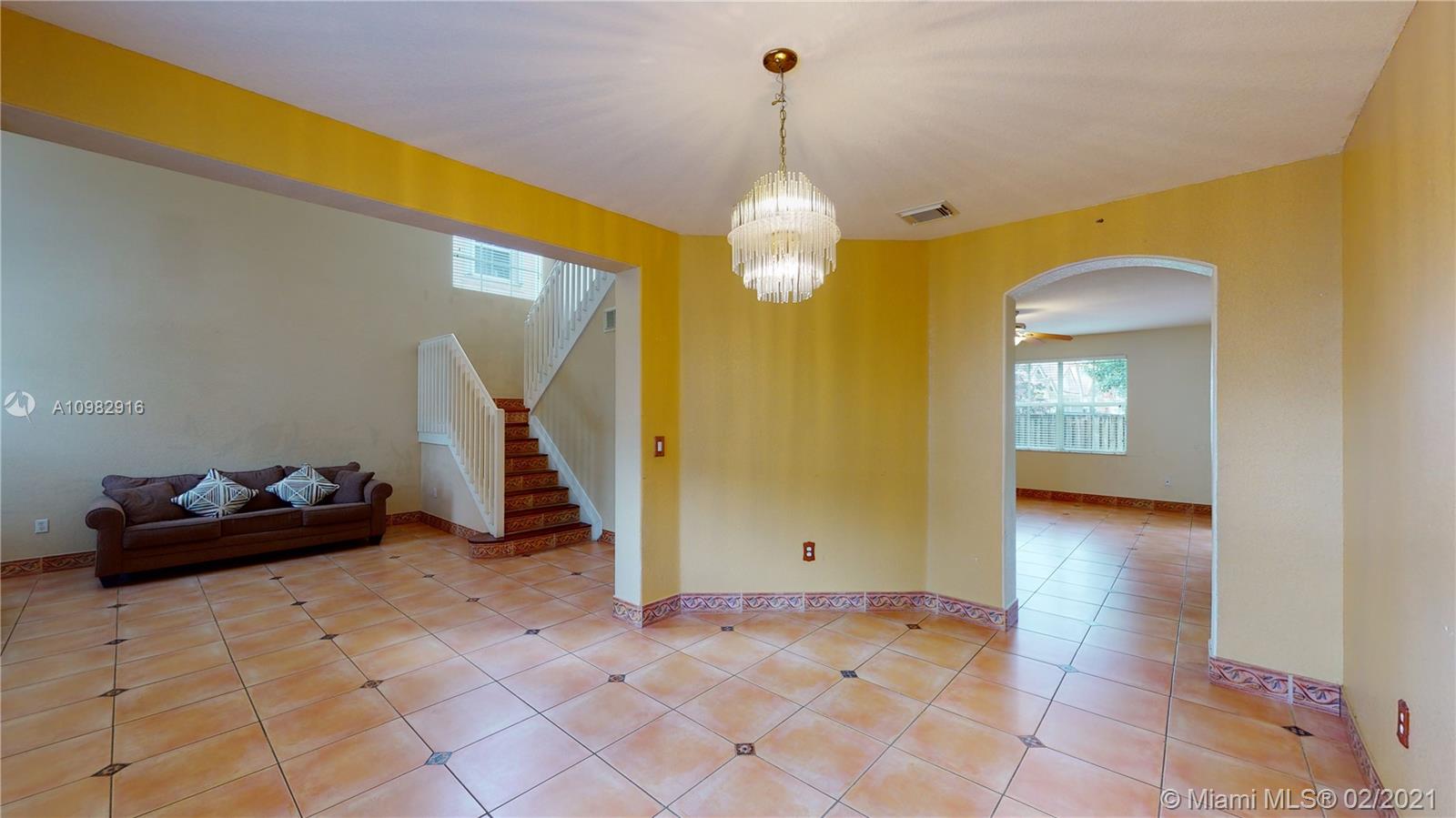 12355 Southwest 124th Terrace Miami, FL 33186 - Photo 12 of 61 a view of a room with a chandelier and wooden floor
