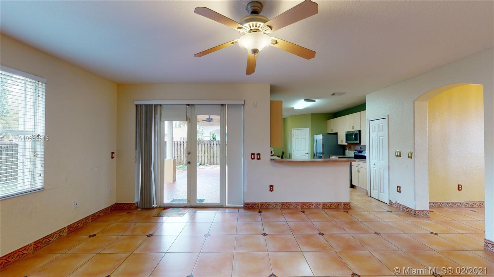 12355 Southwest 124th Terrace Miami, FL 33186 - Photo 14 of 61 a view of an empty room with window and a kitchen