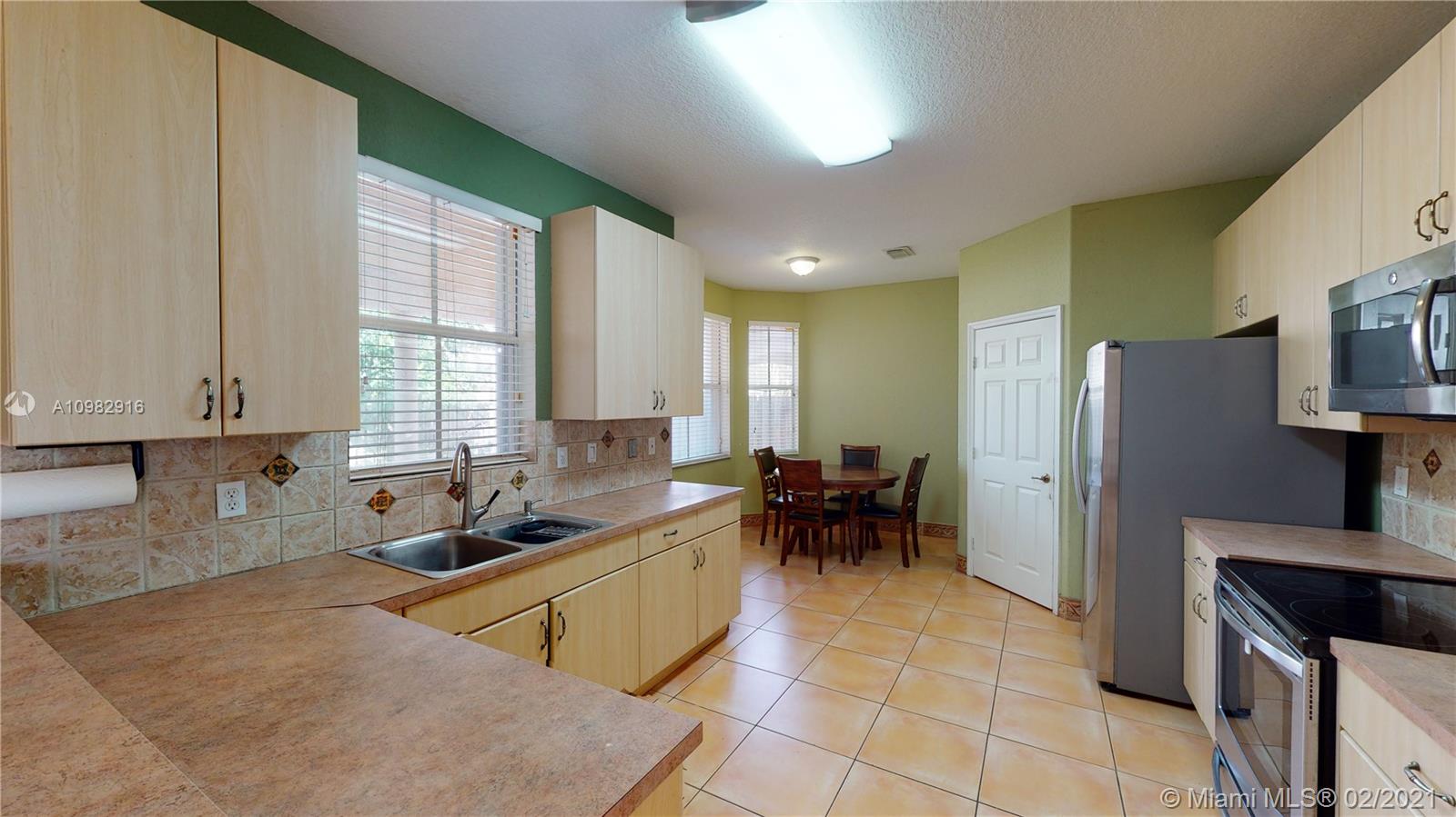 12355 Southwest 124th Terrace Miami, FL 33186 - Photo 18 of 61 a kitchen with refrigerator and cabinets
