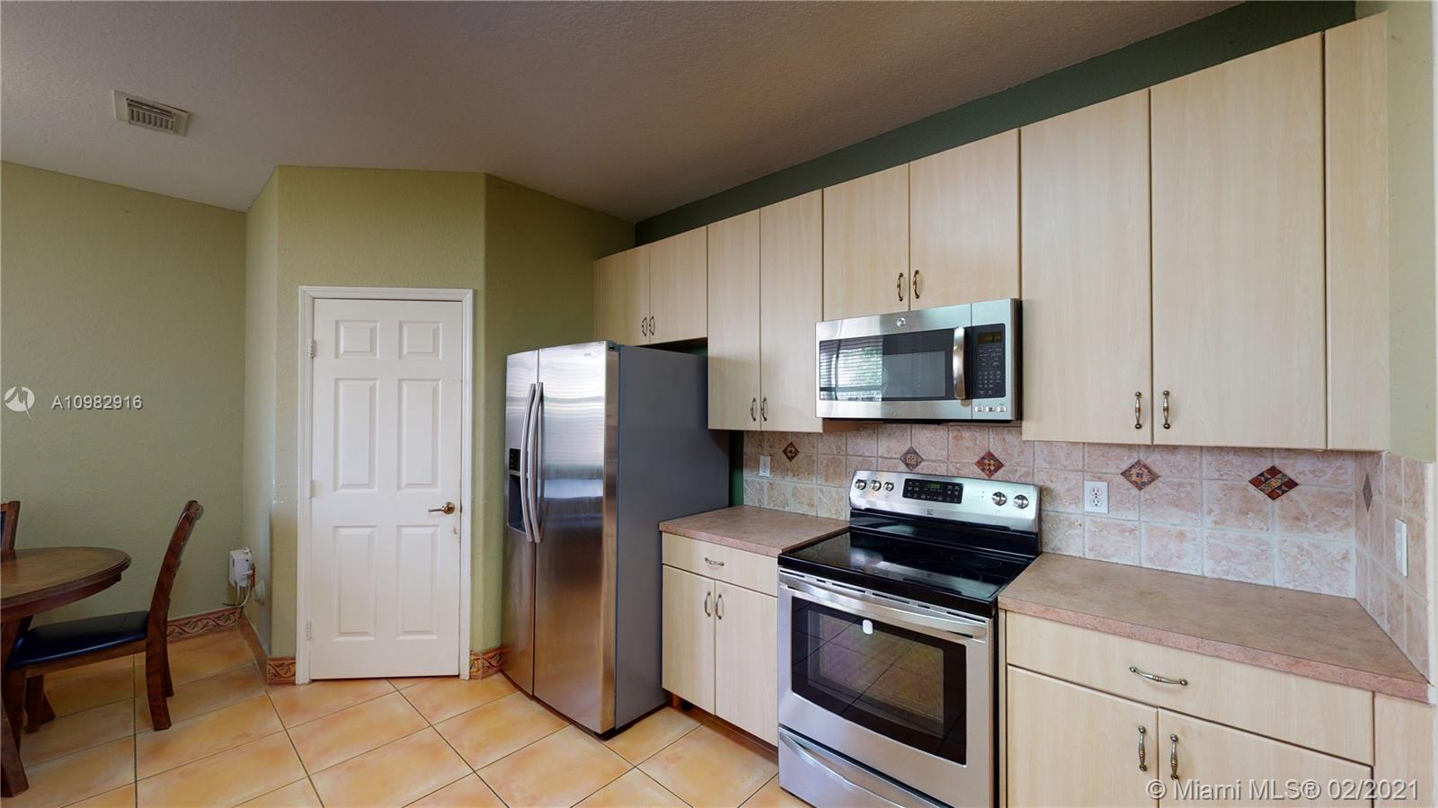 12355 Southwest 124th Terrace Miami, FL 33186 - Photo 20 of 61 a kitchen with stainless steel appliances granite countertop a refrigerator stove and microwave