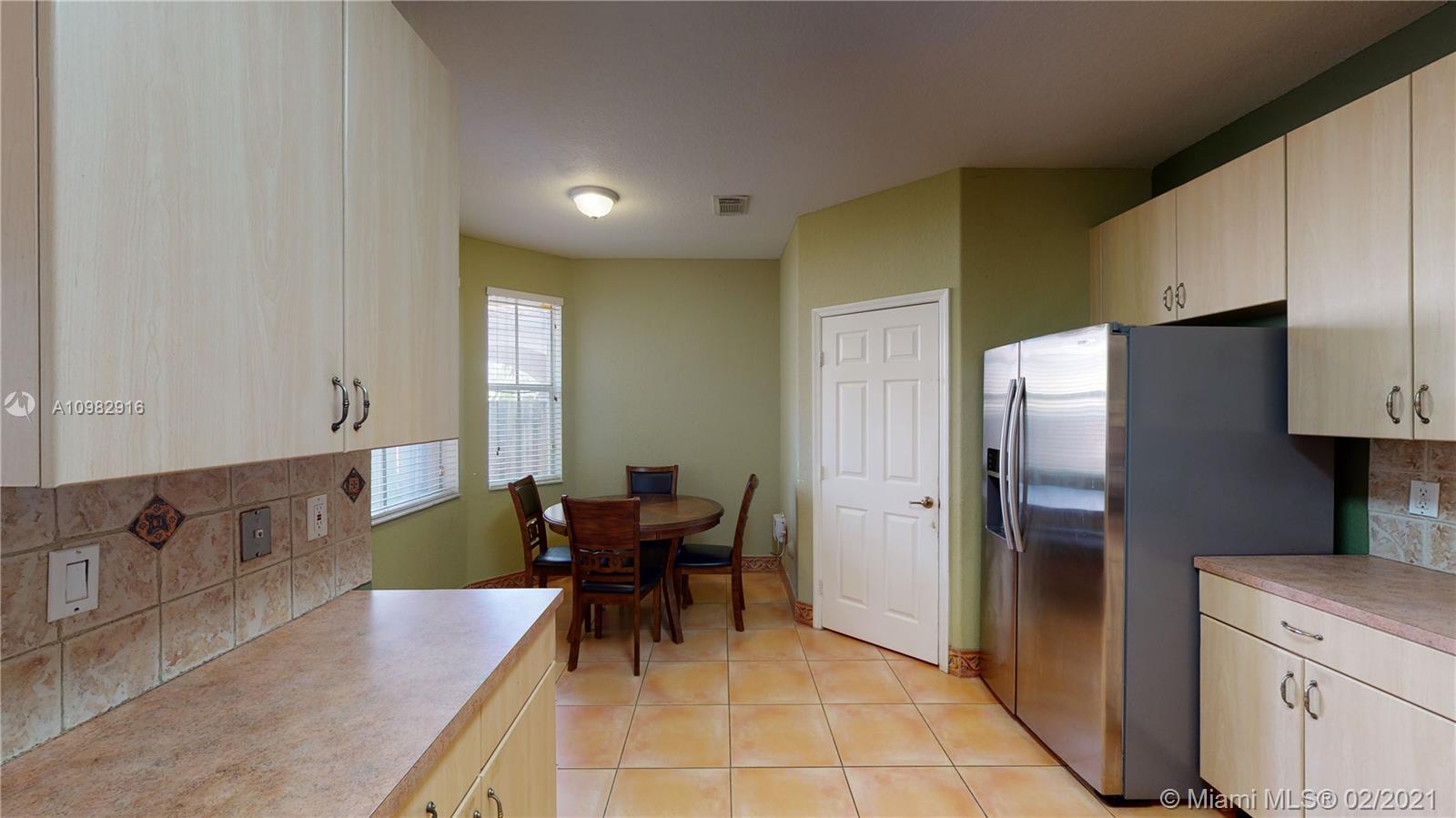 12355 Southwest 124th Terrace Miami, FL 33186 - Photo 21 of 61 a kitchen with stainless steel appliances granite countertop a refrigerator and a stove top oven