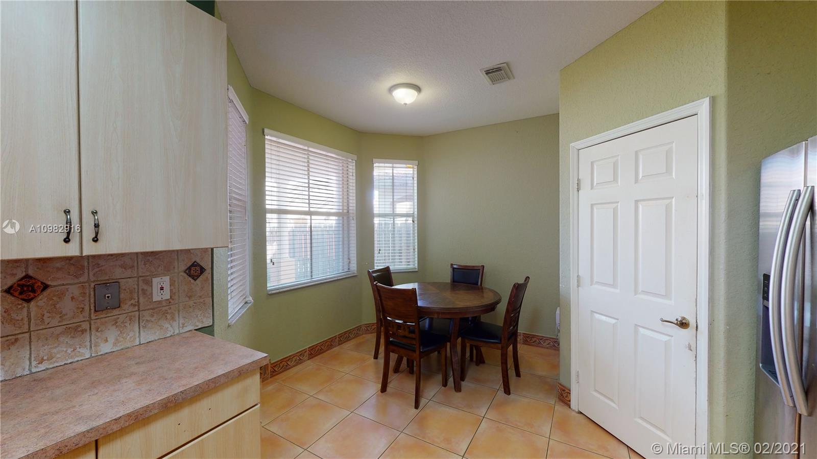12355 Southwest 124th Terrace Miami, FL 33186 - Photo 24 of 61 a view of a dining room with furniture and window