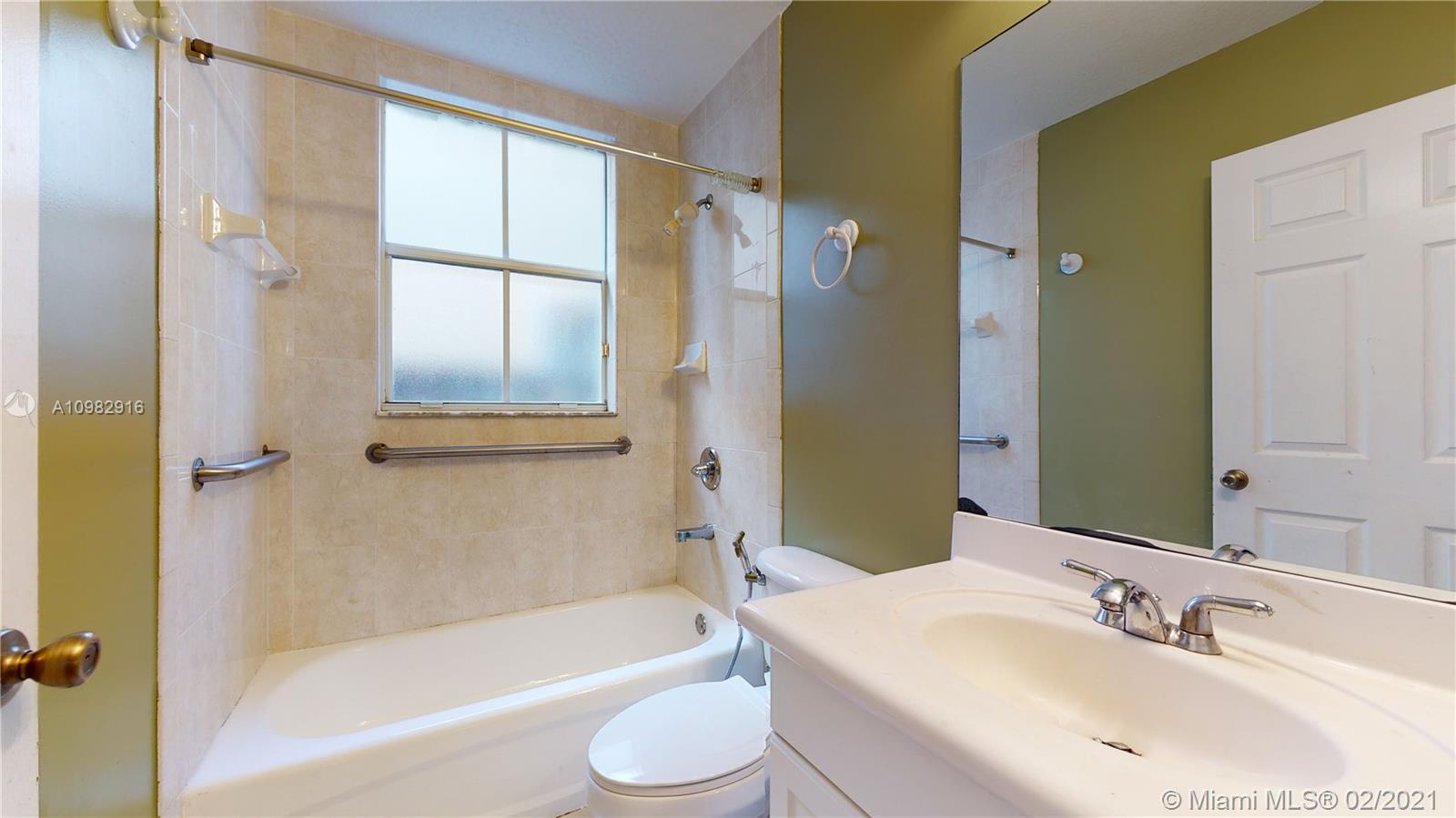 12355 Southwest 124th Terrace Miami, FL 33186 - Photo 29 of 61 a bathroom with a bathtub shower sink vanity and toilet