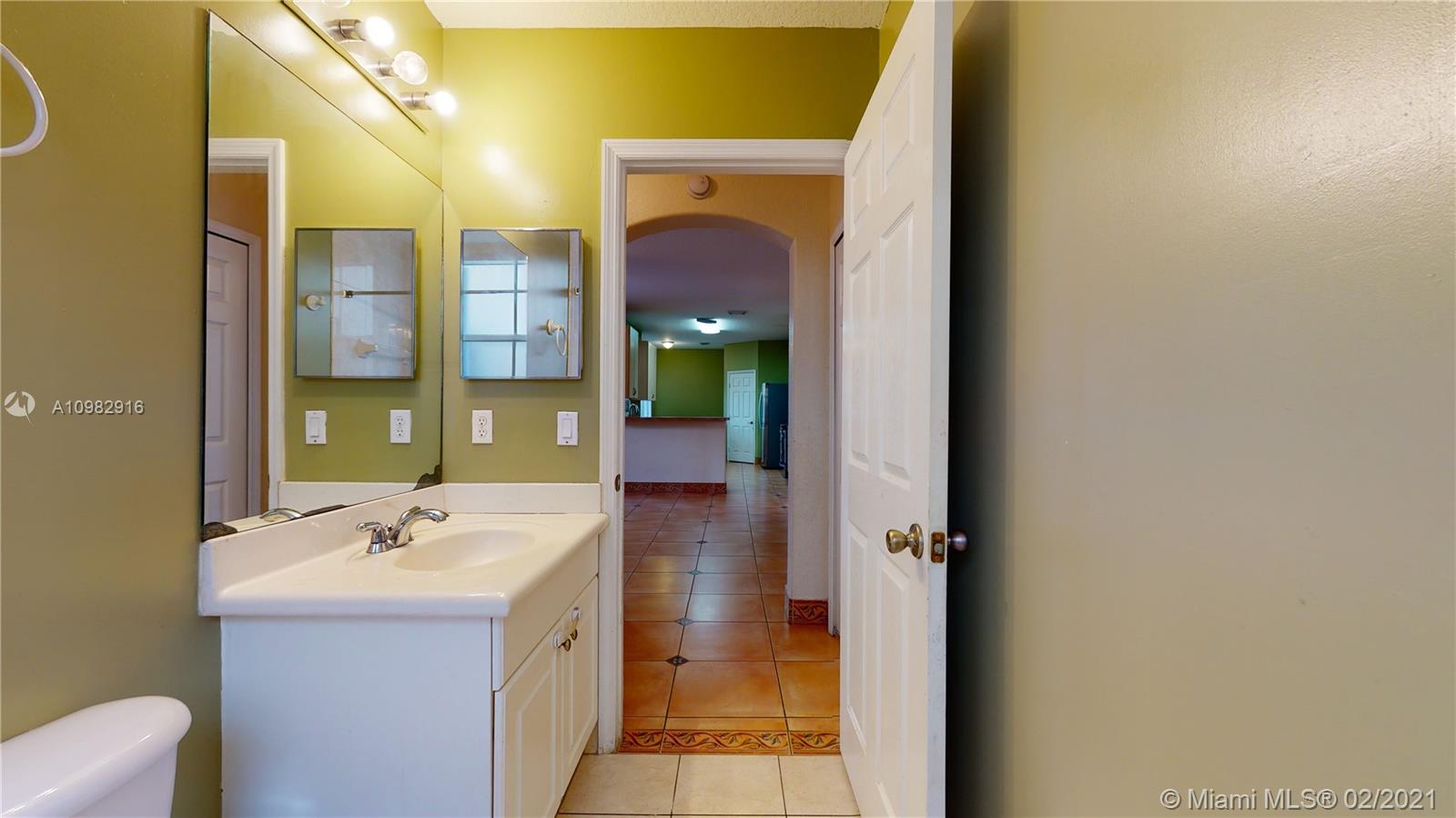 12355 Southwest 124th Terrace Miami, FL 33186 - Photo 30 of 61 a bathroom with a bathtub a sink and a mirror