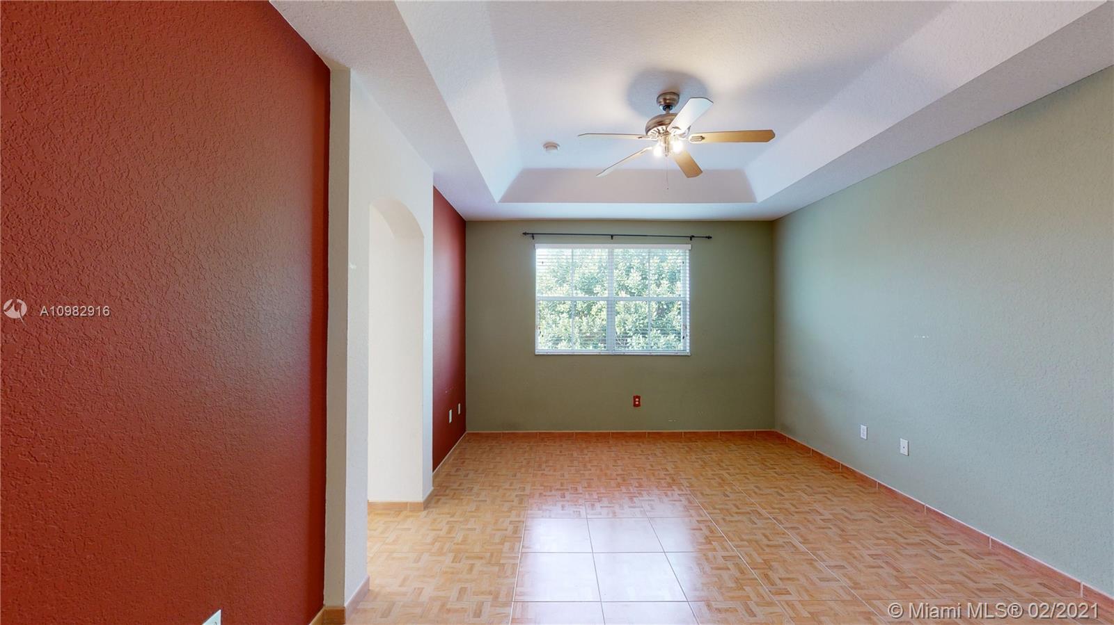12355 Southwest 124th Terrace Miami, FL 33186 - Photo 37 of 61 an empty room with chandelier fan and windows