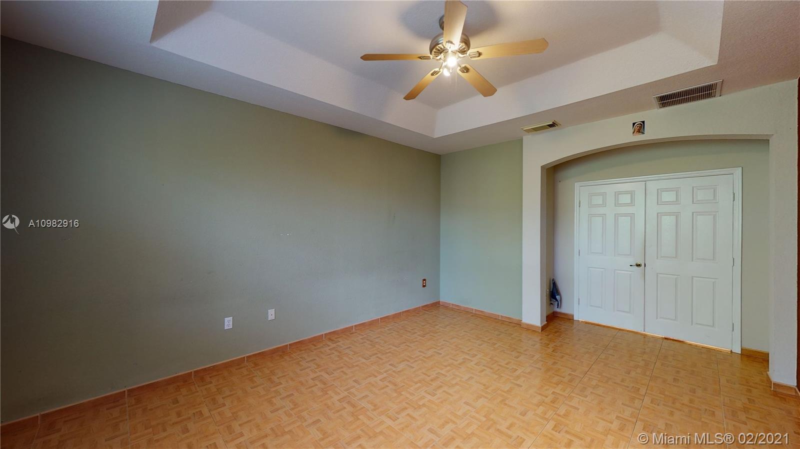 12355 Southwest 124th Terrace Miami, FL 33186 - Photo 39 of 61 an empty room with a ceiling fan and a window