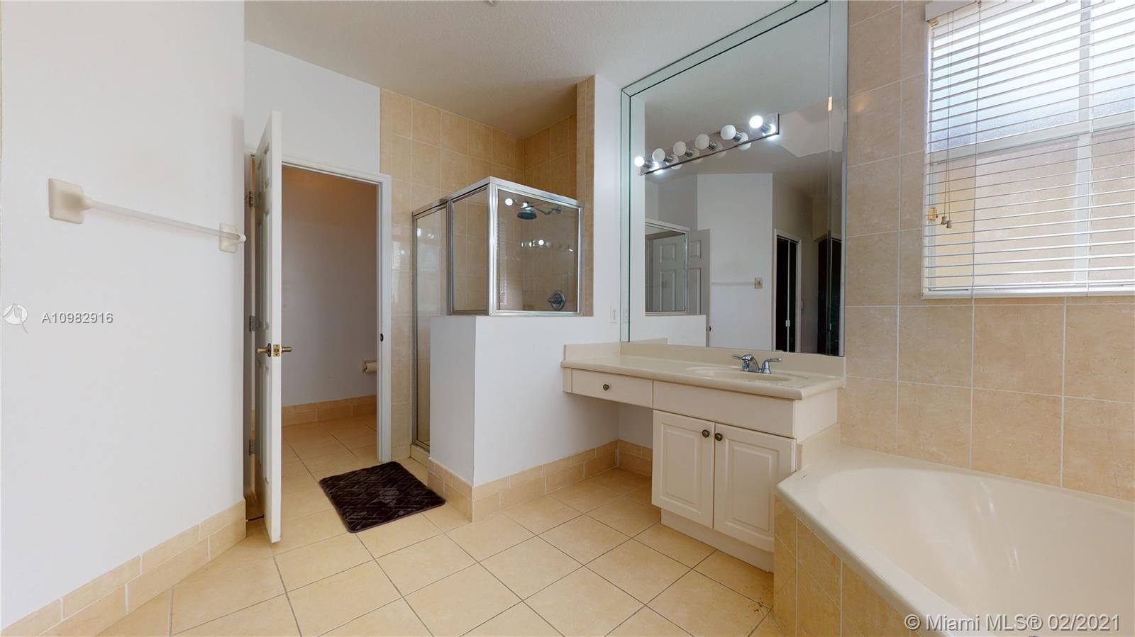 12355 Southwest 124th Terrace Miami, FL 33186 - Photo 41 of 61 a spacious bathroom with a bathtub sink and mirror