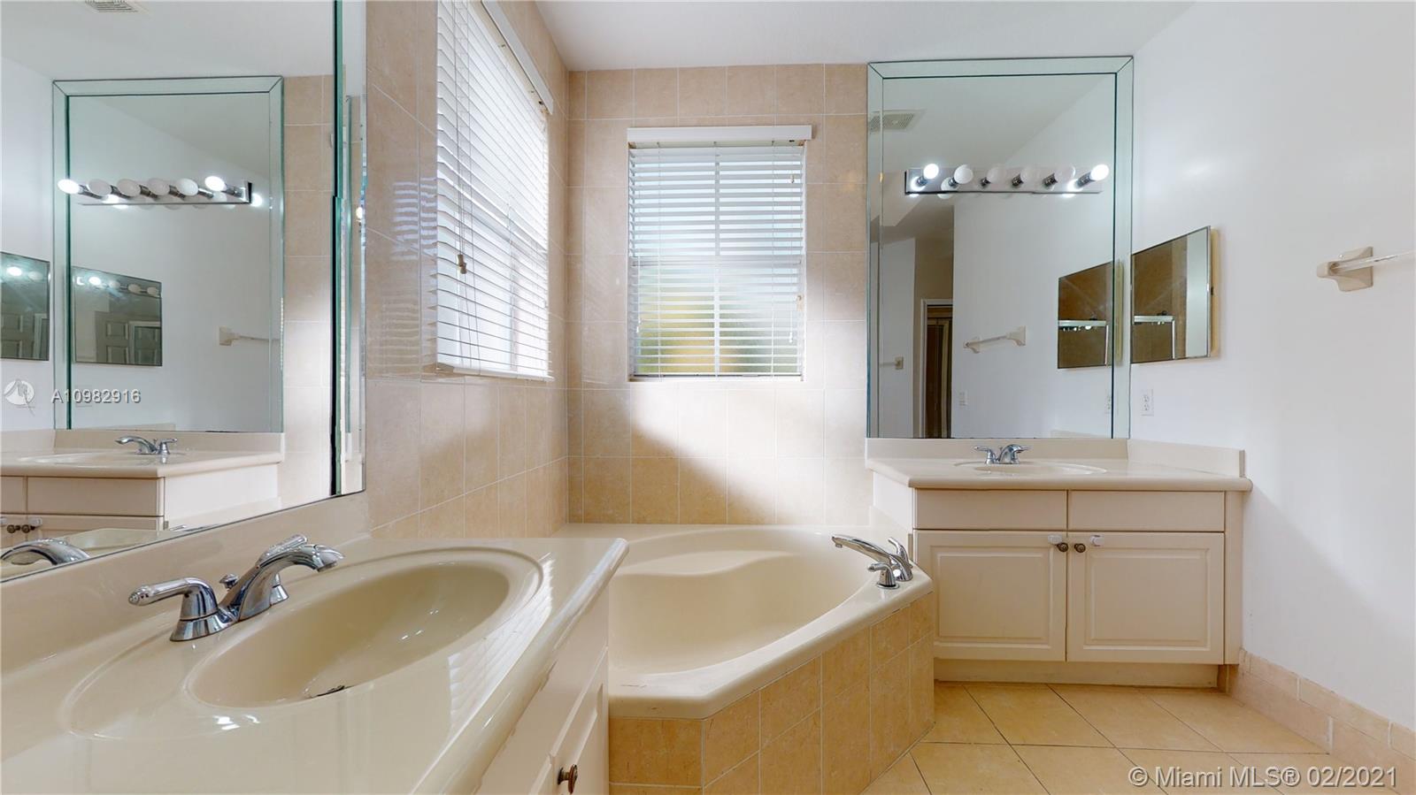 12355 Southwest 124th Terrace Miami, FL 33186 - Photo 42 of 61 a bathroom with a tub sink and mirror