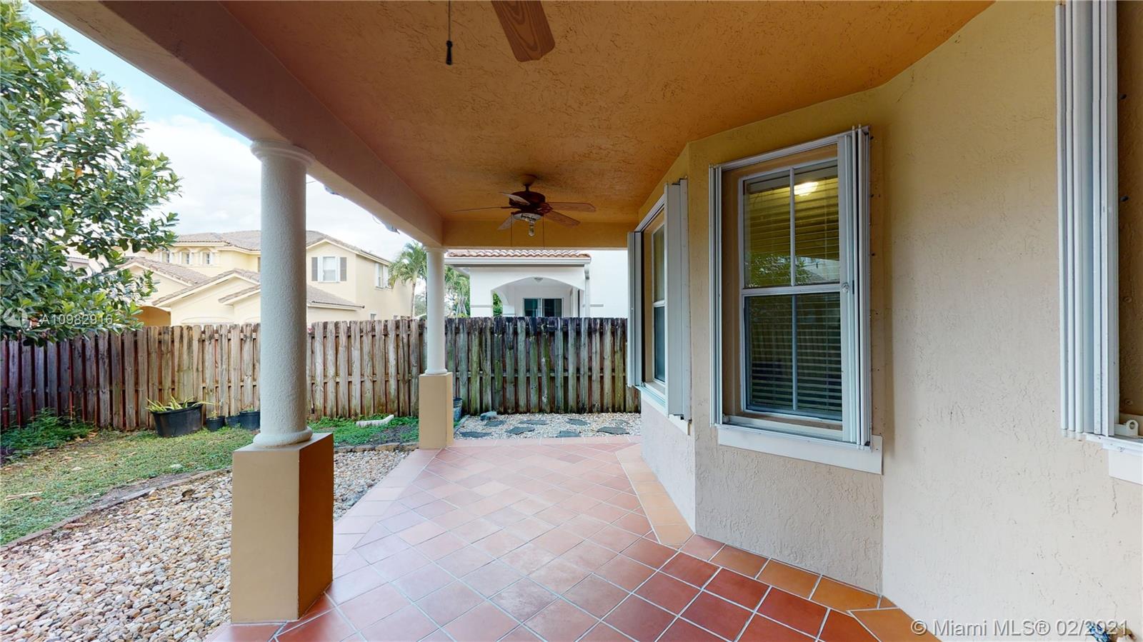 12355 Southwest 124th Terrace Miami, FL 33186 - Photo 54 of 61 a view of a porch with a floor to ceiling window and wooden fence