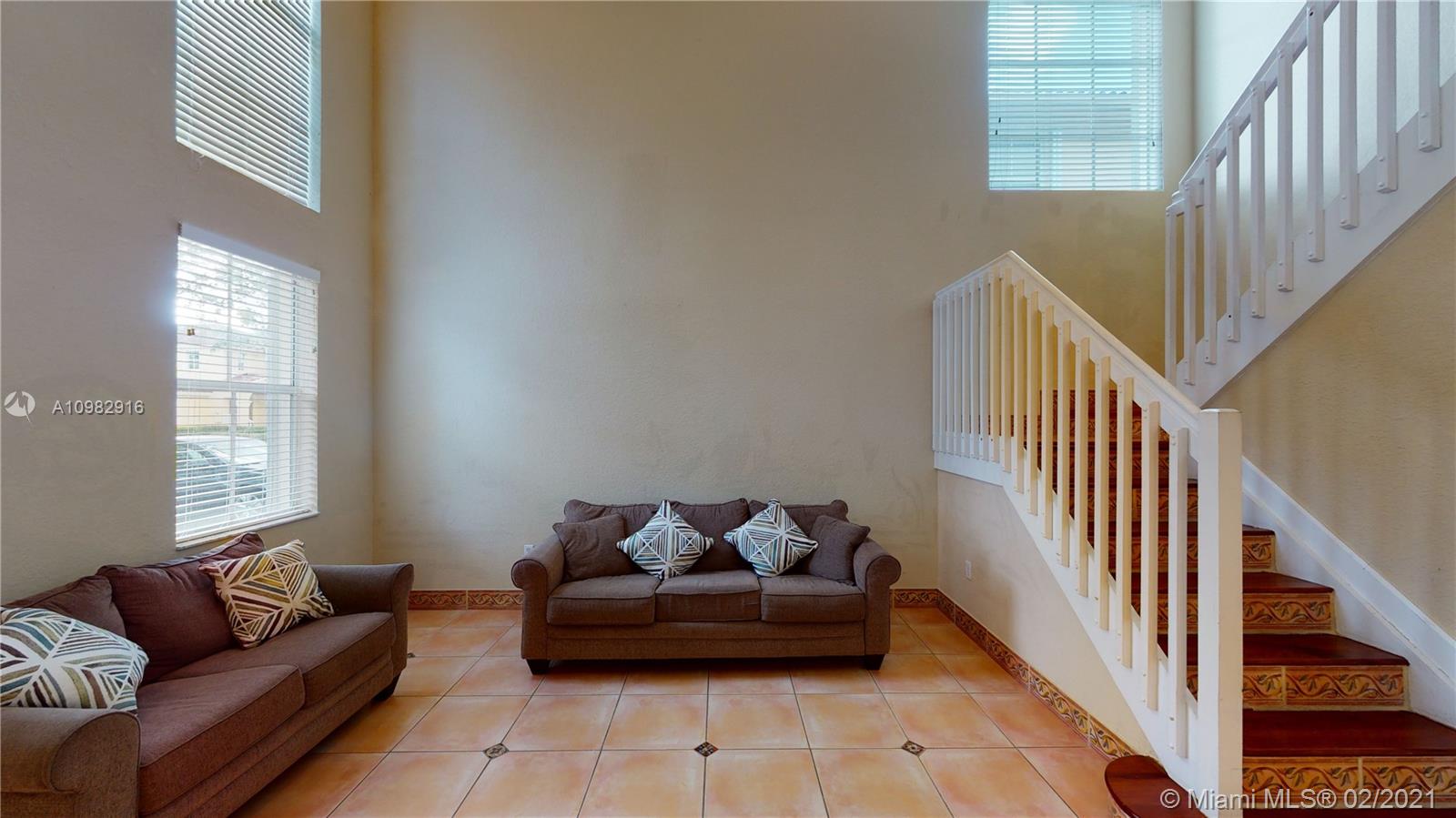 12355 Southwest 124th Terrace Miami, FL 33186 - Photo 9 of 61 a living room with furniture and stairs