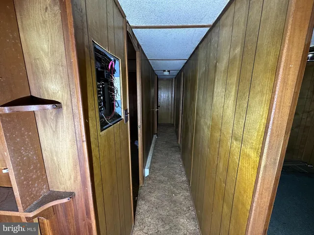 a view of hallway with wooden floor