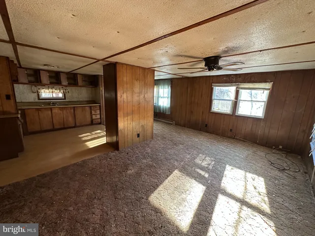 a view of a hallway with stairs and a window