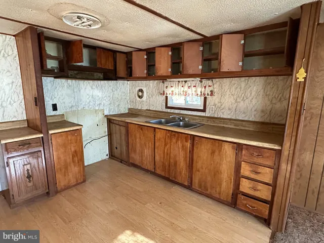 a kitchen with stainless steel appliances granite countertop a sink and a stove
