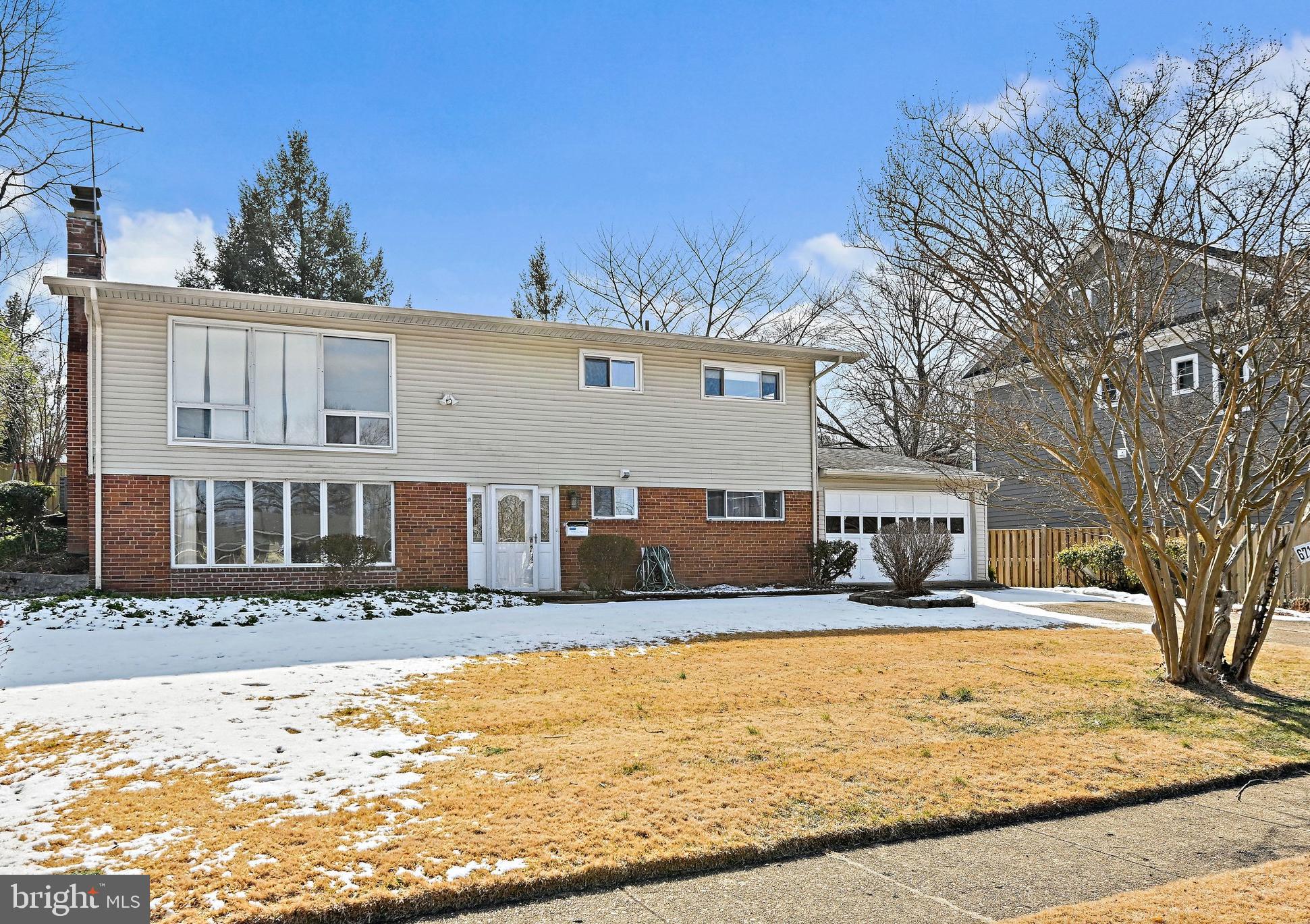 6713 Old Chesterbrook Road McLean, VA 22101 - Photo 1 of 38 a front view of a house with snow on the road