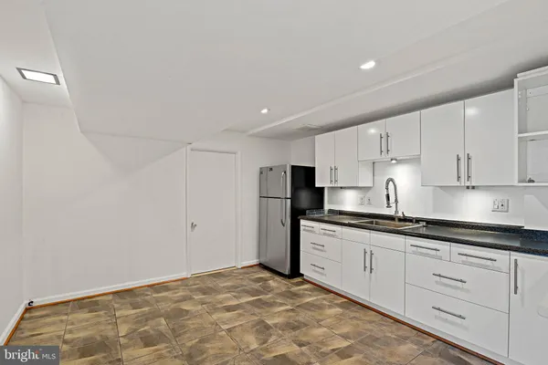 a kitchen with stainless steel appliances granite countertop a sink and cabinets